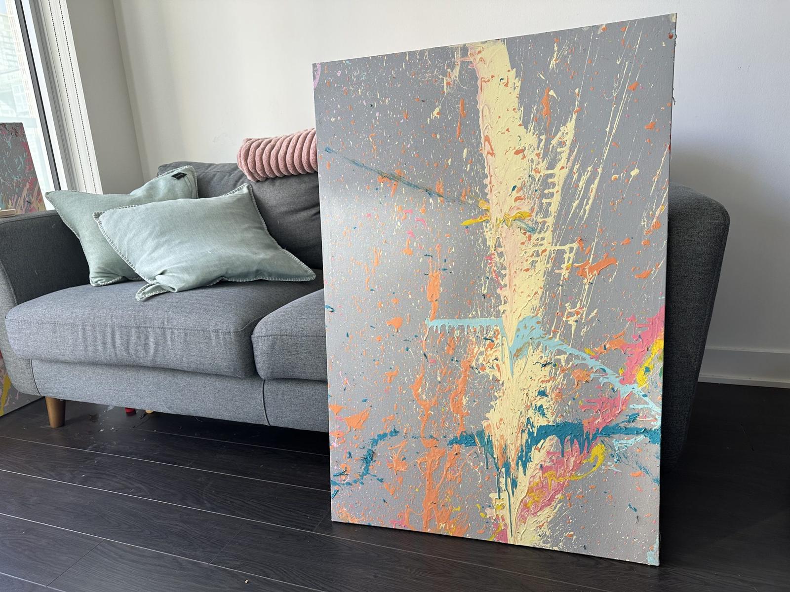 Milkshake No. 2, a horizontal painting with a cream and yellow streak across grey canvas, in a living room